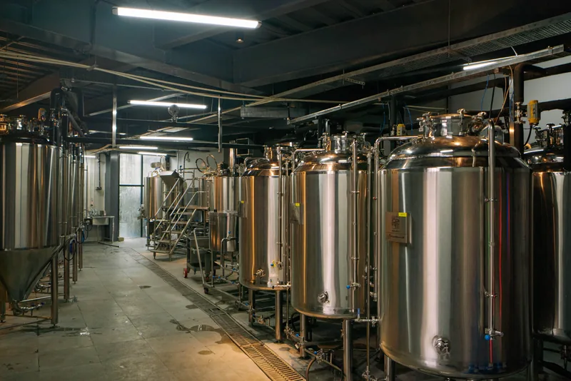 Stainless steel brewing tanks inside Akan’s in-house brewery in Madhapur