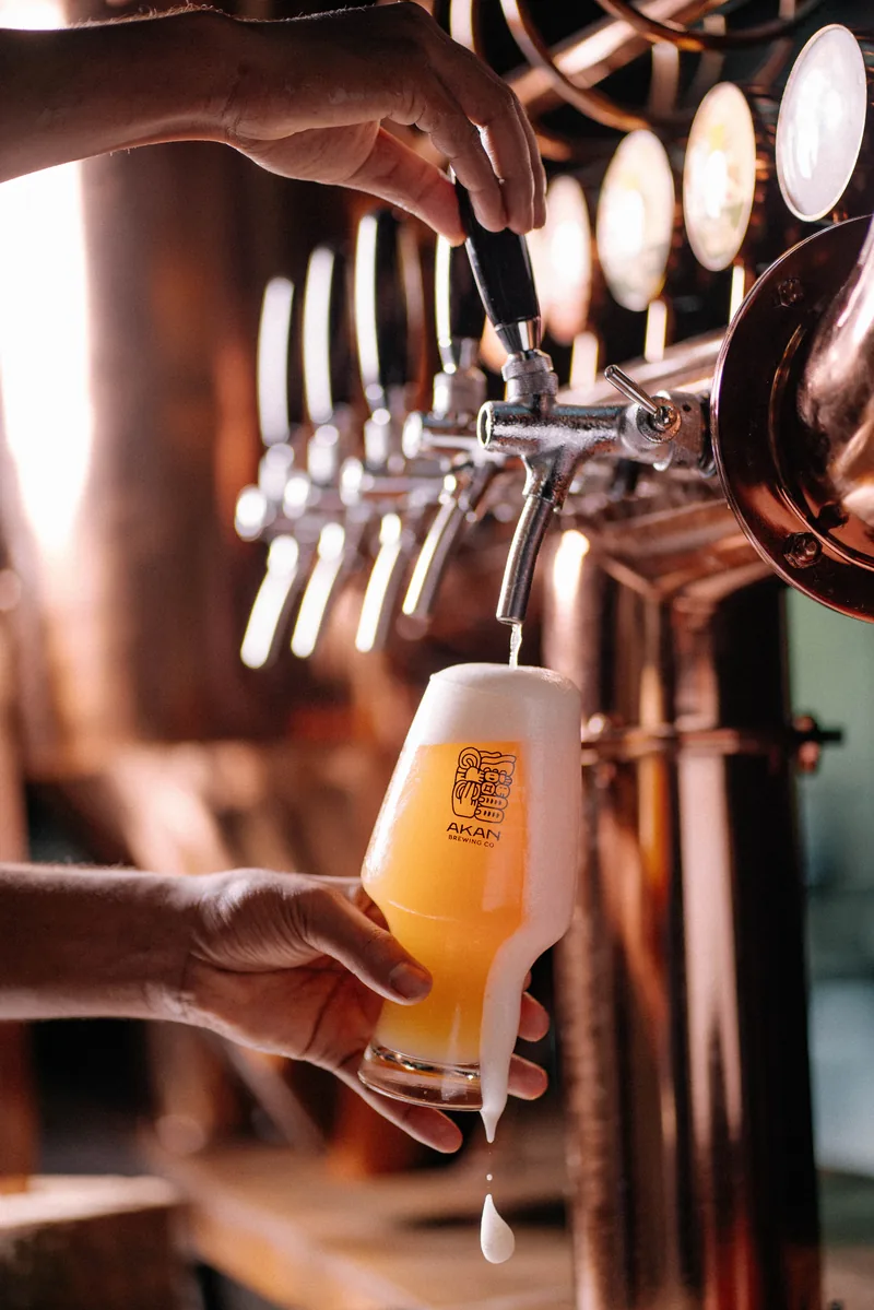 A fresh beer being poured from Akan’s tap into a branded glass